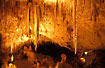 Lit-up cave with stalachites and stalagmites