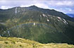 Rainbow in the valley seen from above in the mountains