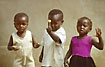 African children waves and show proudly a lollipop
