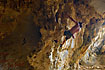 Climber explores a cave in the mogote mountains