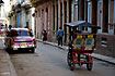 Rickshaw and old american car in Havana vieja