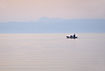 Fishing boat on its way out in the gulf in the early morning light