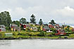 Red and yellow tree houses on little island in the Oslo fiord