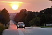 Summer evening with a sunset over the road and cars