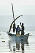 Fishermen with fishing net on fisher boat