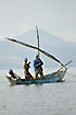Fishermen with fishing net on fishing boat