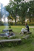 Woman reading at the fire on a midsummer evening
