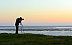 Photographer photographing the sunset at the Wadden Sea
