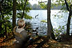 Boy feeding ducks at lake shore
