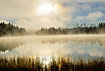 Morning fog covering the sun and a swedish lake