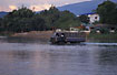 A truck passes the river in Vang Vieng