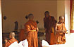 Monks in sunshine by Pha That Luang