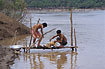 Local cambodians cleaning a roasted dog in the Mekong River