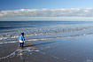 Young lad walking on a beach in Western Jutland