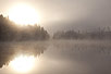 Misty sunrise over a swedish forest lake