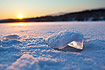 Sunrise over ice covered lake