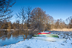 Canoes on a snowcowered riverbank