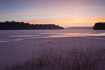 Sunrise over frozen lake