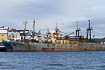 Rusty russian fishing vessel in Btsfjord harbour by the Barents Sea in northern Norway