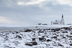 Winter landscape by the Varanger Fiord with the picturesque Nesseby Church
