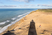 Shadow of a lighthouse on the dynamic coast of Northern Jutland