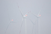 Wind turbines in misty weather