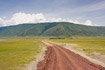 Gravel road through savannah landscape in the Ngorongoro Crater