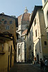 The Duomo of Florence seen through one of the narrow streets