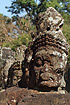 Row of demon heads carved in stone at Angkor Thom in Cambodia
