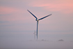 Wind turbine generating electricity a foggy morning