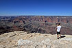 A tourist is photographing the Grand Canyon