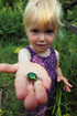 Young girl proudly holding a Metallic Green Chafer