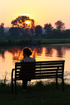 Woman enjoying the sunset at a swedish lake/pond