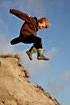 Boy jumping in dunes
