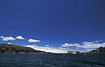 A bus is ferried over a part of Lake Titicaca on a minute ferry.