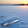 Ice on a frozen lake at sunrise